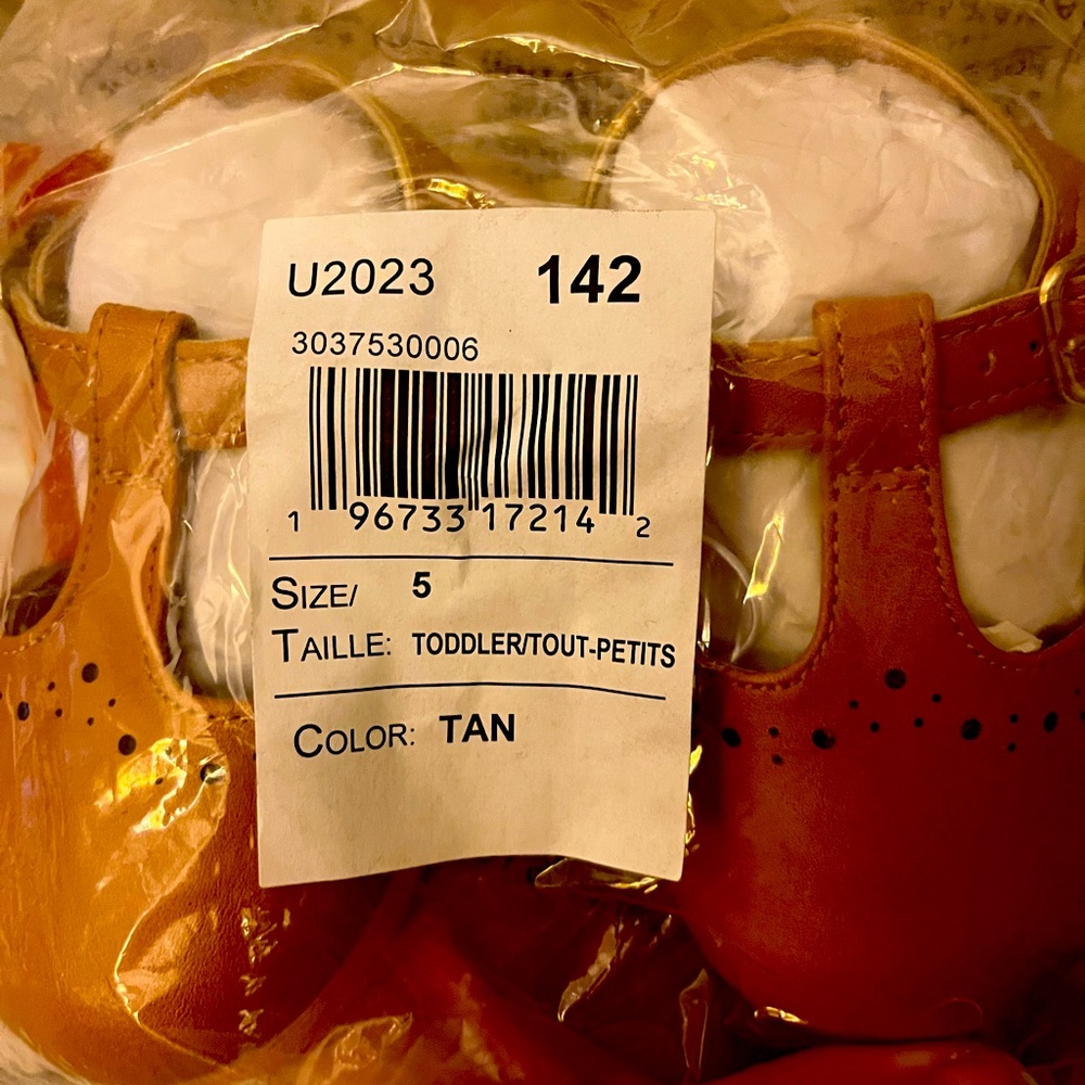 Tan colored baby shoes.